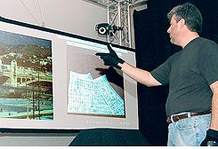 [Kevin Parent, a Raytheon consultant, demonstrates the defense contractor's 'gesture  technology' inspired by a futuristic film.]