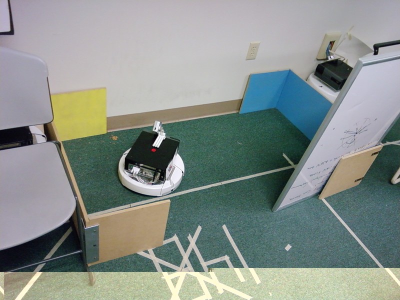 The rectangular enclosure, with its exit located along one long side.