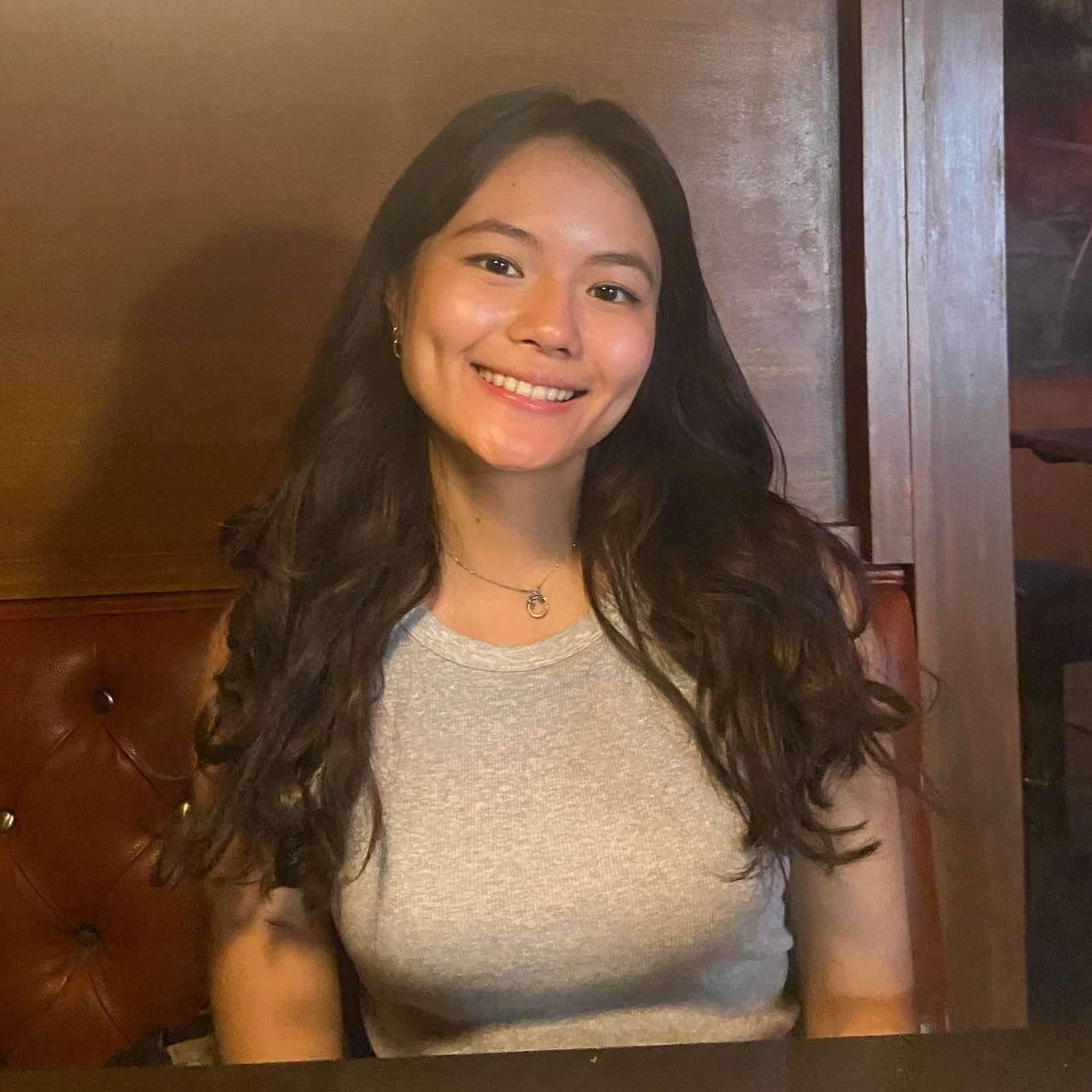 Smiling woman with long brown hair.