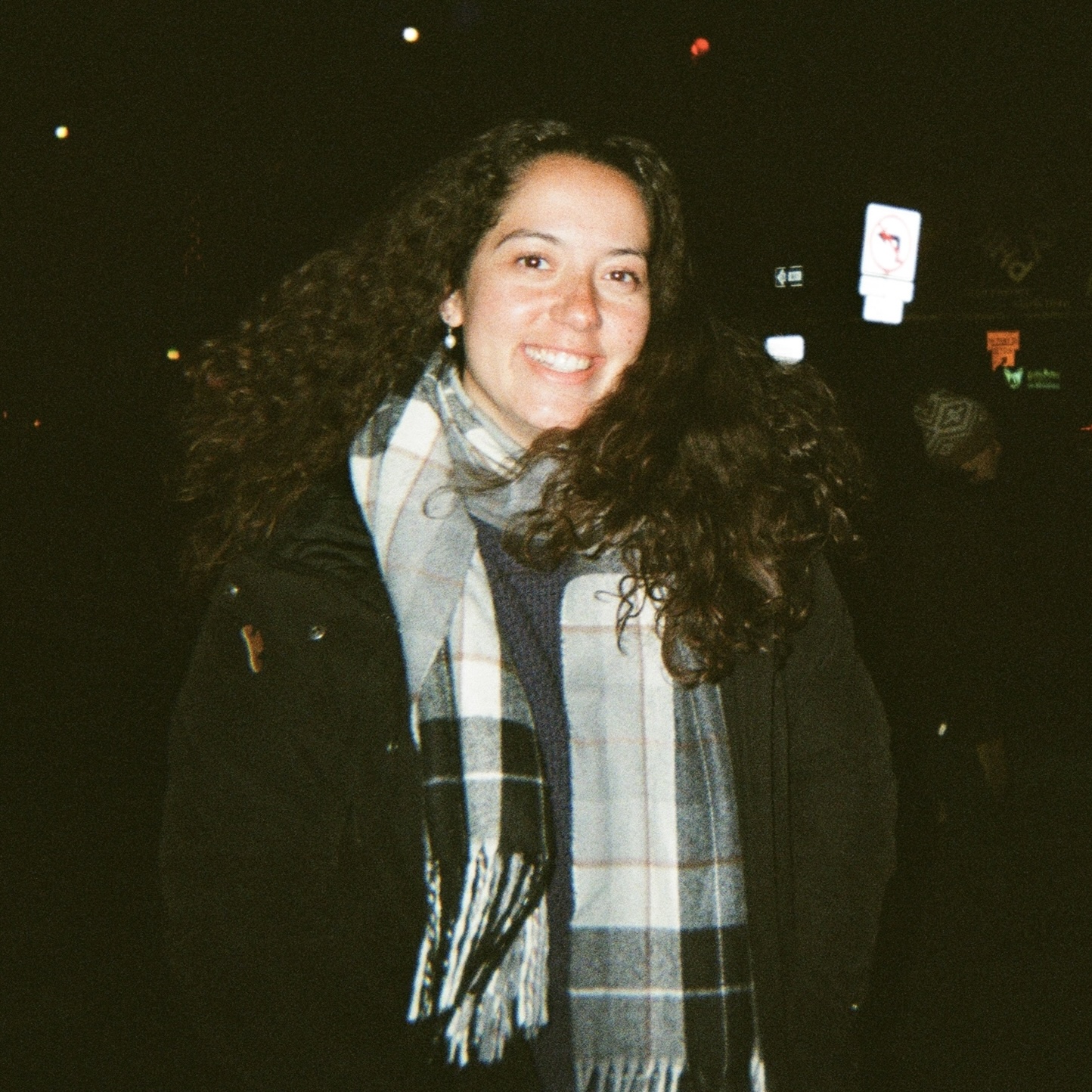 A smiling girl wearing a scarf.
