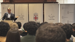 Standing at a podium in front of a crowd, Yann LeCun delivers his lecture
